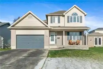 View of property featuring a front yard, a porch, and a garage