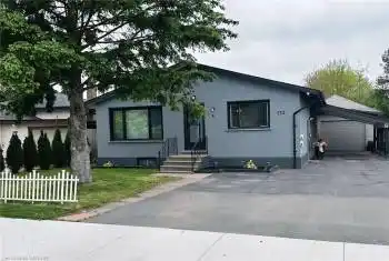 Ranch-style home featuring a front yard and a garage