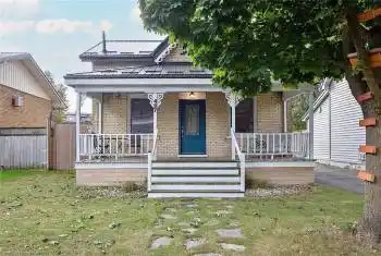 Bungalow-style house featuring covered porch and a front yard