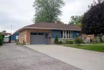 View of front of home with a front yard and a garage