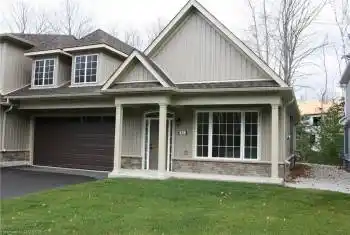 View of front of property featuring a garage and a front yard